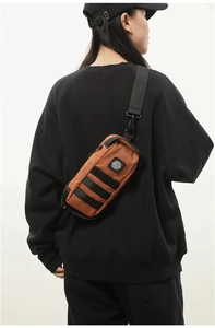 Detail showing amber tactical crossbody chest bag with durable nylon and strap detail
