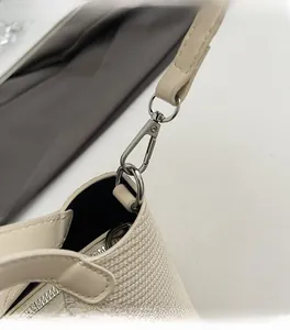 Detail of silver lobster clasp and cream woven texture on this stylish handbag strap