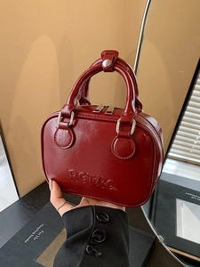 Retro red glossy mini bowling bag with embossed lettering and stylish top handle design