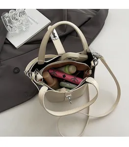 Interior view of beige bucket bag showing ample space for phone, wallet and cosmetics
