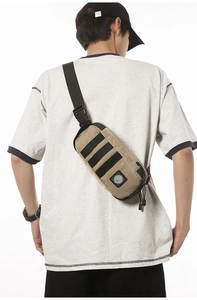 Detail showing tactical chest bag with MOLLE webbing and adjustable strap on a person