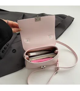 Detailed interior view of a pink crossbody bag showing capacity for phone and makeup
