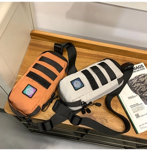 Tactical chest bags in bright orange and grey with MOLLE webbing and brand logo