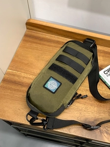 Waterproof army green tactical chest bag with adjustable strap and durable nylon fabric