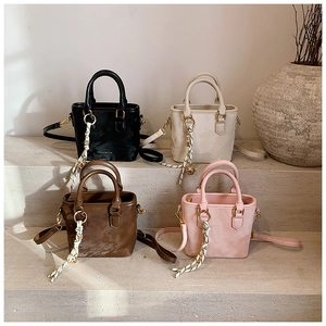 Mini tote bags in black, cream, coffee, and pink with woven pendants and shoulder straps