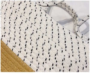 Detail of the woven straw bag featuring bicolor stitching and a polka dot texture