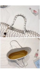 Detail of woven straw bag with contrast yellow interior and wooden bead tassel ornament