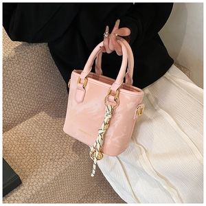 Detail of pink PU leather handbag with cloud texture and black and white plaid scarf