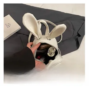 Close-up of internal storage showing space for phone and perfume in white bunny backpack