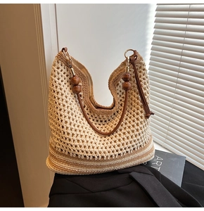 Detailed texture of hollow woven shoulder bag with dark brown wood beads handle