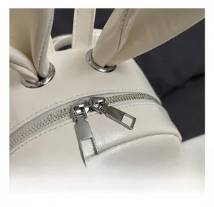 Close-up of white PU leather backpack featuring cute bunny ears and durable silver zippers