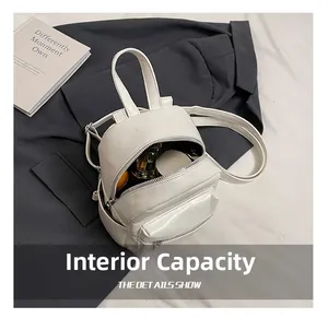 Internal capacity of mini white leather backpack showing storage for daily essentials