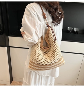 Hollow crochet tote bag with brown stripe detail and wooden beads on shoulder strap