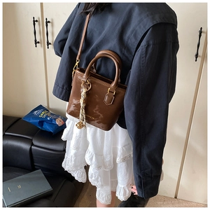 Brown vintage leather tote bag with silk scarf charm and detachable crossbody strap