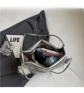 Silver metallic tote bag interior showing large capacity for phone and tablet
