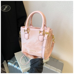 Detail of pink marble pattern bucket bag with golden hardware and fashion lettering