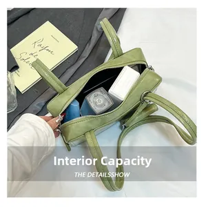 Top view of green pillow bag interior showing large capacity for cosmetics and perfume