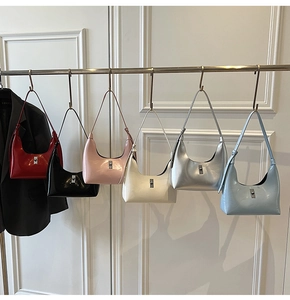 Row of crescent shoulder bags in six vibrant colors with polished metallic buckles