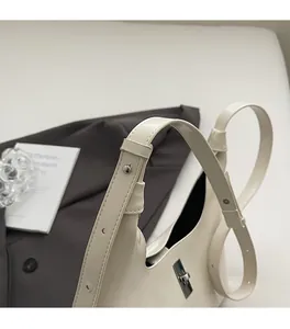 Detailed close-up of premium cream leather bag with silver metal buckle and strap