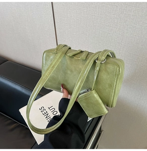 Close-up of green rectangular shoulder bag in shiny faux leather with double straps