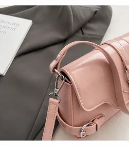 Close-up of pink glossy handbag showing high-quality silver metal hardware and texture