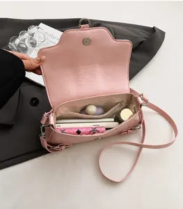 Pink shoulder bag interior showing dual main compartments and zipper pocket for storage