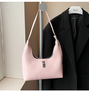 Detail of pink patent leather hobo bag with silver twist lock and glossy mirror finish