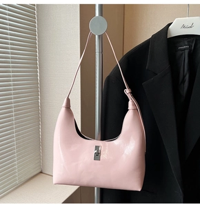 Pink matte leather hobo bag featuring a silver rectangular twist lock on a shoulder strap