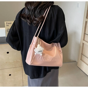 Detailed back view of pink tote bag with MIKAXIQI logo and white plush monster charm