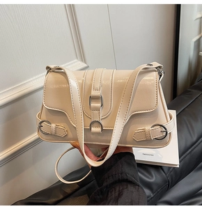 Gros plan du sac bandoulière crème en cuir froissé avec boucles métalliques argentées