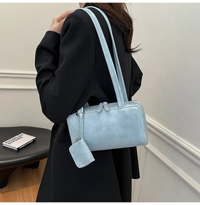Light blue faux leather shoulder bag with vintage texture and matching small pouch