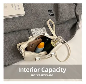 Internal capacity of the cream mini boston bag showing spacious storage for daily items