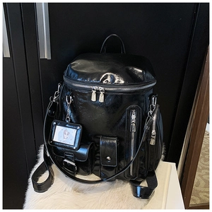 Detail of a black glossy backpack with multiple pockets and a cute clear card holder