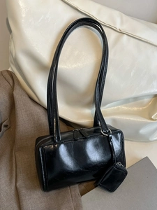 Glossy black underarm pillow bag with adjustable shoulder strap and mini coin purse