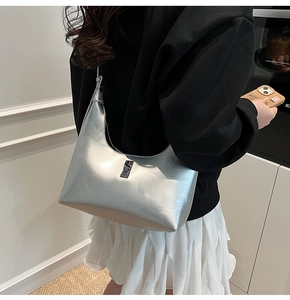 Modern metallic silver hobo bag with sleek buckle detail shown in a lifestyle setting