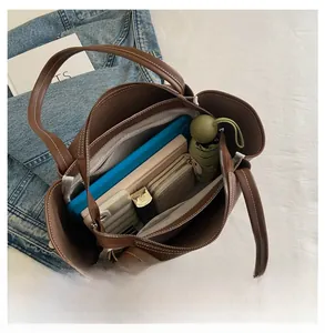 Interior view of brown tote bag showing capacity for tablet, umbrella, and wallet