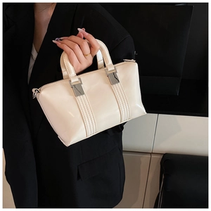 Detail of off-white rectangle handbag with silver hardware and vertical stitching