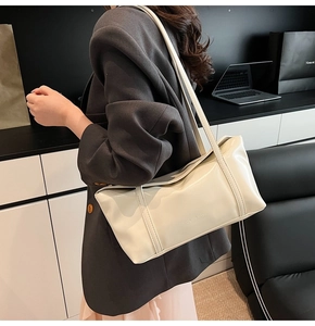 Detail view of cream white tote bag with CLEAR OK embossed logo and slim shoulder straps