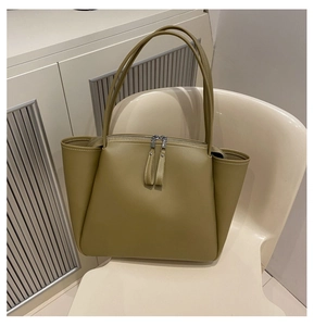 Detail of khaki olive tote bag featuring double zippers and side storage pockets