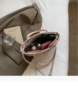 Vista dall'alto dell'interno spazioso della borsa rosa con telefono e profumi