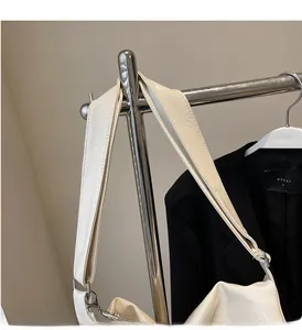 Detail of cream oil wax leather tote showing wrinkled texture and metal buckle