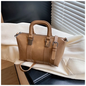 Detailed macro view of the shiny khaki boston bag with silver hardware and fine texture