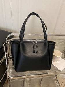 Black large tote bag with white contrast stitching and dual zipper on silver metal stand