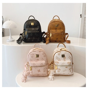 Detailed collection of mini leather backpacks in black, brown, pink and white with bear charms
