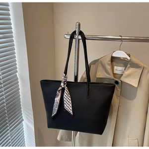 Close-up of black lychee texture tote bag featuring a decorative patterned silk scarf