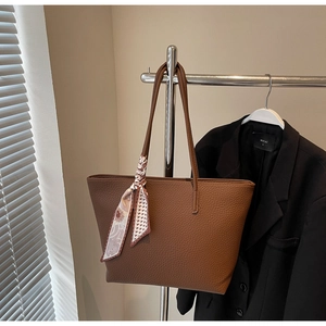 Brown pebble leather tote bag detail with silk scarf and long shoulder straps for work