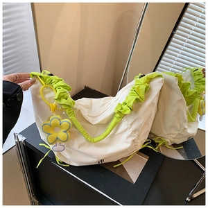 Détail du sac bandoulière blanc cassé avec une bandoulière à volants vert vif