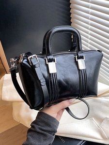 Glossy black Boston handbag with silver hardware and shoulder strap, elegant style