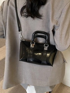 Elegant black patent leather handbag for women featuring silver hardware and crossbody strap