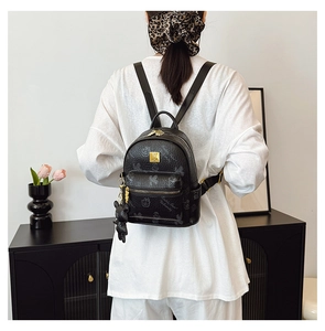 Detail of black mini backpack with Friendly Bear print and gold hardware accent